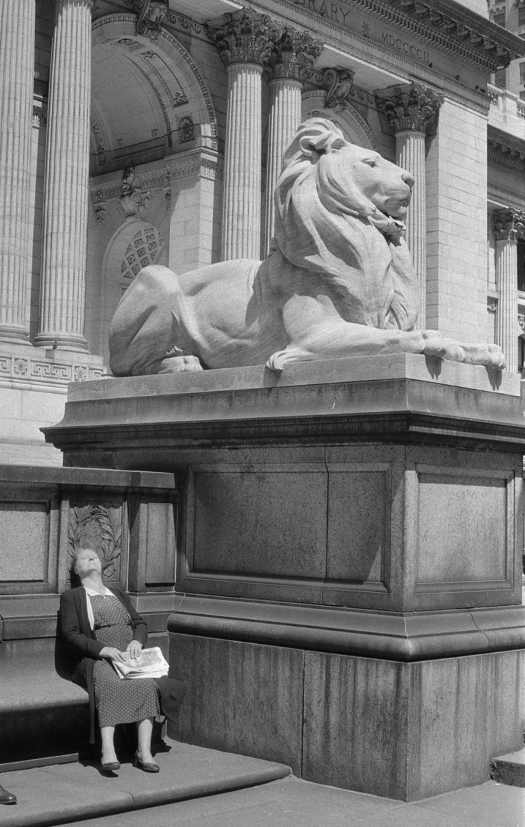 A woman suns herself outside the entrance to the New York Public Library in 1955 in this photo, called \"Lady and the Lion.\"